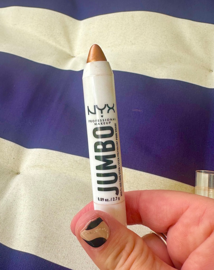 Photo of the NYX Multi-Use Stick in Flan, a golden-bronze shade. 